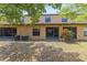 Back view of the house with a small, tree-covered yard at 2441 Hibiscus Bay Ln, Brandon, FL 33511