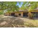 A serene backyard featuring ample shade trees and a peaceful screened in patio at 2441 Hibiscus Bay Ln, Brandon, FL 33511