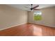 Spacious bedroom with hardwood floors, a ceiling fan, and a bright window at 2441 Hibiscus Bay Ln, Brandon, FL 33511