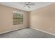 Neutral bedroom with a window and gray carpet at 2441 Hibiscus Bay Ln, Brandon, FL 33511