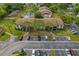 Aerial view of the community showing building exteriors and parking lot at 2699 Pine Ridge E Way # H1, Palm Harbor, FL 34684
