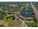 Pine Ridge community aerial view highlighting the lake, pool, and clubhouse amenities at 2699 Pine Ridge E Way # H1, Palm Harbor, FL 34684