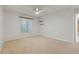Bright bedroom with neutral carpet, ceiling fan, white walls, and two wall shelves at 2699 Pine Ridge E Way # H1, Palm Harbor, FL 34684