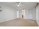 Bright bedroom with neutral carpet, closet, ceiling fan, and white walls at 2699 Pine Ridge E Way # H1, Palm Harbor, FL 34684