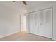 Bright bedroom with neutral carpet, closet, ceiling fan, and white walls at 2699 Pine Ridge E Way # H1, Palm Harbor, FL 34684