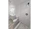 Bathroom featuring a marble tiled shower, a single sink vanity with mirror and wood look flooring at 2712 60Th N Ave, St Petersburg, FL 33714