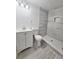 Updated bathroom featuring a modern vanity, toilet, and a tiled walk-in shower with a niche at 2712 60Th N Ave, St Petersburg, FL 33714