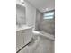 Bright bathroom featuring a tiled shower with a glass window and a modern vanity with new fixtures at 2712 60Th N Ave, St Petersburg, FL 33714