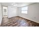 Bedroom featuring wood-look floors, window and closet with bathroom access at 2712 60Th N Ave, St Petersburg, FL 33714