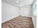 Bedroom with wood-look flooring, a closet, and a window with white walls at 2712 60Th N Ave, St Petersburg, FL 33714