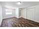 Bright bedroom with wood-look flooring, white walls, and a closet for ample storage at 2712 60Th N Ave, St Petersburg, FL 33714