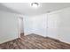 Clean bedroom with wood-look flooring, white walls, and a classic white interior door at 2712 60Th N Ave, St Petersburg, FL 33714