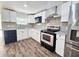 Charming kitchen with stainless steel appliances, granite countertops, and sleek black and white cabinetry at 2712 60Th N Ave, St Petersburg, FL 33714