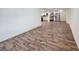 Open-concept living space with laminate floors leading to a modern kitchen and stainless steel appliances at 2712 60Th N Ave, St Petersburg, FL 33714