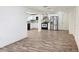 Open floor plan showcasing laminate flooring connecting the living area to a modern kitchen at 2712 60Th N Ave, St Petersburg, FL 33714