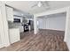 Open floor plan living room and kitchen featuring dark brown hardwood flooring and stainless steel appliances at 2712 60Th N Ave, St Petersburg, FL 33714