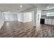 Open floor plan living room and kitchen featuring dark brown hardwood flooring, stainless steel appliances and white walls at 2712 60Th N Ave, St Petersburg, FL 33714