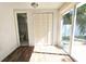 A sunny living area with wood floors, closet, and glass door to yard provides indoor-outdoor flow at 2712 60Th N Ave, St Petersburg, FL 33714