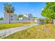 Large backyard with a palm tree and a long driveway to the carport at 2827 1St Ne St, St Petersburg, FL 33704