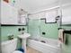 Retro bathroom with sleek glass shower doors, vintage tile, and pedestal sink at 2827 1St Ne St, St Petersburg, FL 33704