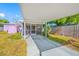 Covered carport with access to a screened patio and lush landscaping at 2827 1St Ne St, St Petersburg, FL 33704