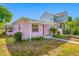 Exterior view of a pink home with an open porch and a screened in lanai at 2827 1St Ne St, St Petersburg, FL 33704