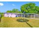 Backyard featuring a covered parking area, screened lanai, and lush landscaping at 2827 1St Ne St, St Petersburg, FL 33704
