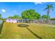 Home with a large grassy yard, long driveway, and covered carport at 2827 1St Ne St, St Petersburg, FL 33704