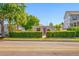 View of a lovely single-story home with a colorful exterior and trimmed hedges at 2827 1St Ne St, St Petersburg, FL 33704