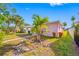 View of the front yard with healthy green plants and a pink painted house at 2827 1St Ne St, St Petersburg, FL 33704