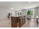 Open-concept kitchen and living area features an island with granite countertops at 3087 Forrest Plum Ct, Zephyrhills, FL 33540