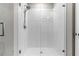 Modern shower featuring glass enclosure and white tile at 3087 Forrest Plum Ct, Zephyrhills, FL 33540