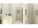 Modern bathroom with a sleek white vanity and a glimpse into the toilet area, offering a clean and minimalist design at 31719 Griffin Sands Ln, San Antonio, FL 33576