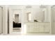 Bright bathroom featuring double sinks with a clean white vanity, complemented by a view into an adjoining bedroom at 31719 Griffin Sands Ln, San Antonio, FL 33576