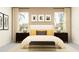 Serene bedroom featuring a plush bed with decorative pillows, complemented by stylish nightstands and elegant lamps at 31719 Griffin Sands Ln, San Antonio, FL 33576