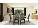 Dining room featuring a round table with six black chairs, complemented by hardwood floors and neutral walls at 31719 Griffin Sands Ln, San Antonio, FL 33576