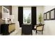 Well-lit home office with a dark wood desk, modern chair, stylish decor, and a large window view at 31719 Griffin Sands Ln, San Antonio, FL 33576