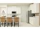 Bright kitchen with white cabinets, stainless steel appliances, counter seating and white countertops at 31719 Griffin Sands Ln, San Antonio, FL 33576