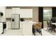 Contemporary kitchen with white cabinetry, stainless steel appliances, and a breakfast bar with stylish seating at 31719 Griffin Sands Ln, San Antonio, FL 33576