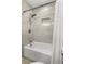 Modern shower and tub area with tiled walls and a built-in shelf at 3310 Valencia Rd, Tampa, FL 33618