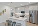Charming kitchen with stainless steel appliances, gray cabinets and an island with barstool seating at 3469 Timber Crossing Ave, Brandon, FL 33511