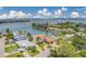 Stunning waterfront property featuring a private boat dock, lush landscaping, and a beautiful home with a terracotta tile roof at 362 41St Ave, St Pete Beach, FL 33706