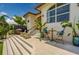 Home backyard with outdoor dining and seating area, a barbeque, and travertine flooring at 362 41St Ave, St Pete Beach, FL 33706