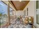Water view balcony offers ample seating and a black and white geometric patterned rug at 362 41St Ave, St Pete Beach, FL 33706