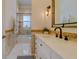 Bright bathroom features a single sink vanity, decorative mirror and accent tiling in the bath/shower area at 362 41St Ave, St Pete Beach, FL 33706