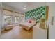 Stylishly decorated bedroom featuring a bed, chair, and leaf-themed wallpaper that creates a relaxing atmosphere at 362 41St Ave, St Pete Beach, FL 33706