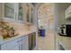 Stylish butler's pantry featuring sleek cabinetry, beverage fridge, and access to the kitchen at 362 41St Ave, St Pete Beach, FL 33706