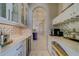 Elegant butler's pantry with wine fridge, ample counter space, and modern backsplash at 362 41St Ave, St Pete Beach, FL 33706