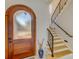 Inviting foyer with a wood door, stylish staircase, and decorative accents showcasing the home's sophisticated design at 362 41St Ave, St Pete Beach, FL 33706