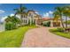 Expansive front yard with lush landscaping frames this two-story Mediterranean-style home at 362 41St Ave, St Pete Beach, FL 33706